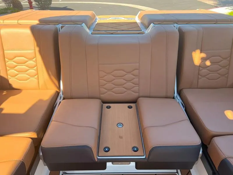 Slide: The Image of 2025 Malibu 23 LSV boat interior with tan leather seating and modern design. - 27