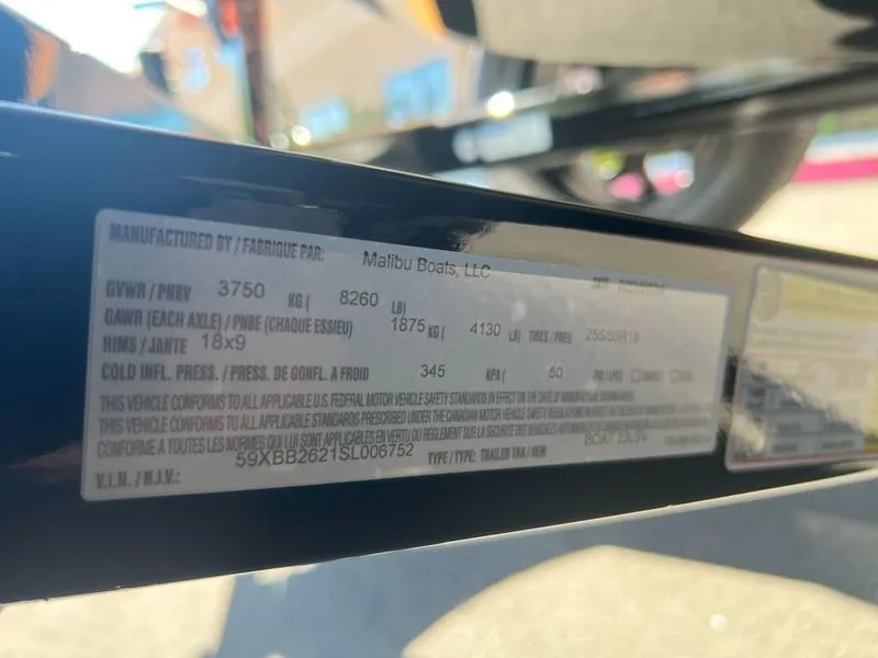 Slide: The Image of 2025 Malibu 23 LSV trailer label with specifications and weight details. - 28