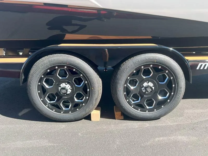 Slide: The Image of 2025 Malibu 23 LSV trailer with black alloy wheels on pavement. - 30