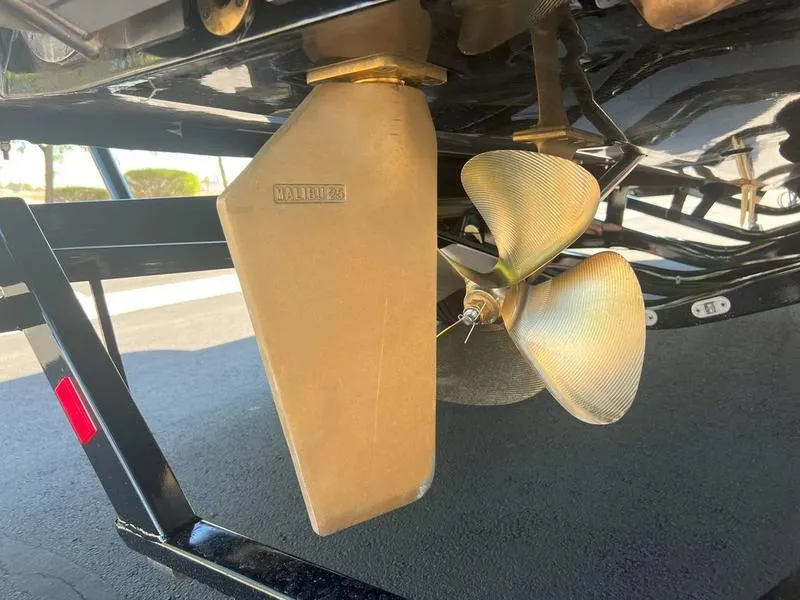 Slide: The Image of 2025 Malibu 23 LSV boat propeller and rudder detail. - 32