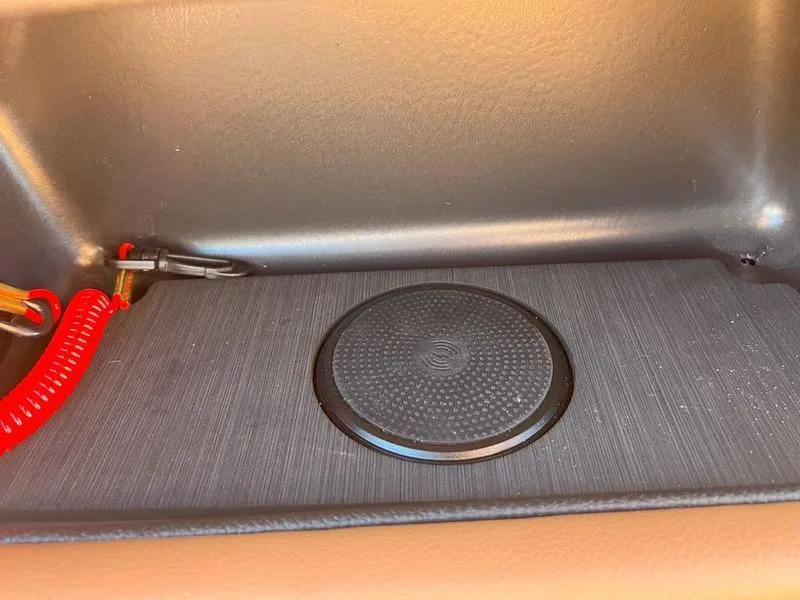 Slide: The Image of 2025 Malibu 23 LSV interior detail with circular speaker and red cable. - 33