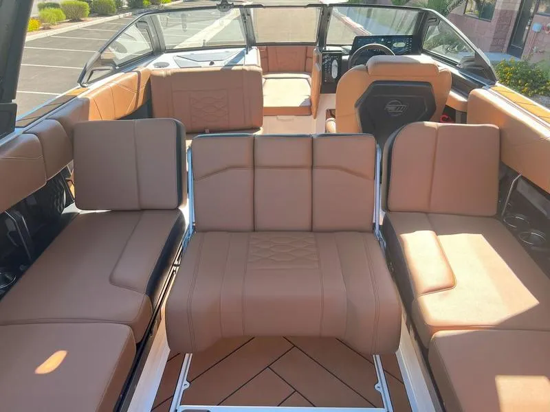 Slide: The Image of 2025 Malibu 23 LSV boat interior with tan leather seating and modern design. - 35