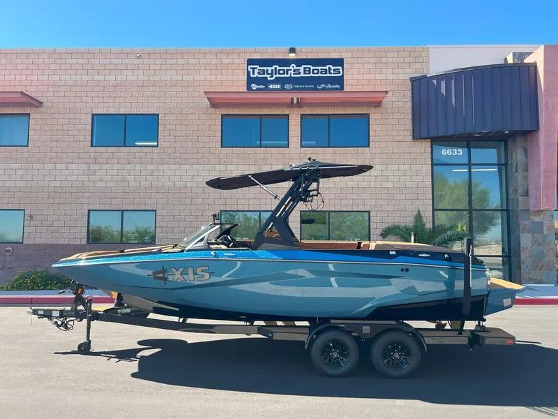 Slide: The Image of 2025 Axis A225 boat on trailer outside Taylor's Boats dealership. - 1