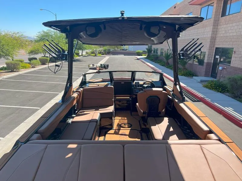 Slide: The Image of 2025 Axis A225 boat with spacious seating and modern design in a parking lot. - 15