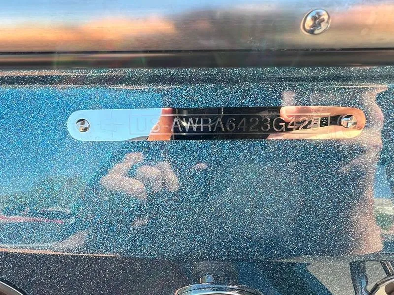 Slide: The Image of Axis A225 2025 model with VIN plate on metallic surface. - 2