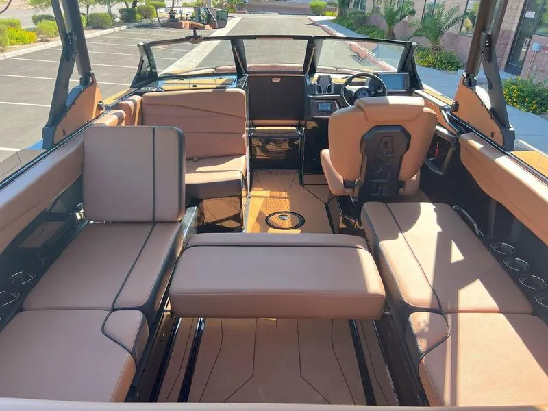Slide: The Image of 2025 Axis A225 boat interior with tan seating and modern dashboard. - 20