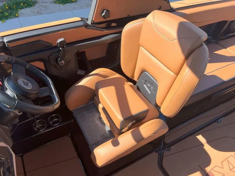 Slide: The Image of 2025 Axis A225 boat interior with tan leather seating and steering wheel. - 22
