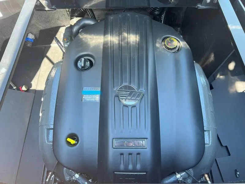 Slide: The Image of 2025 Axis A225 engine compartment with sleek black cover and visible components. - 23