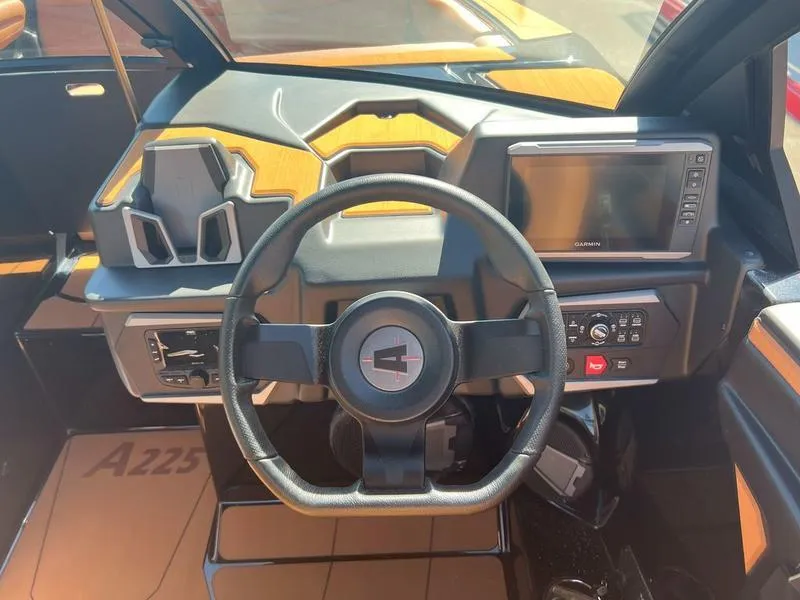 Slide: The Image of 2025 Axis A225 boat dashboard with steering wheel and digital display. - 27