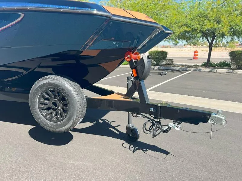 Slide: The Image of Axis A225 boat trailer parked in sunny lot, 2025 model. - 29