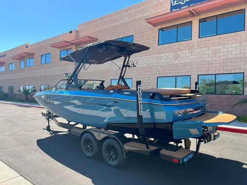 Slide: The Image of 2025 Axis A225 boat on trailer, parked near a brick building. - 3