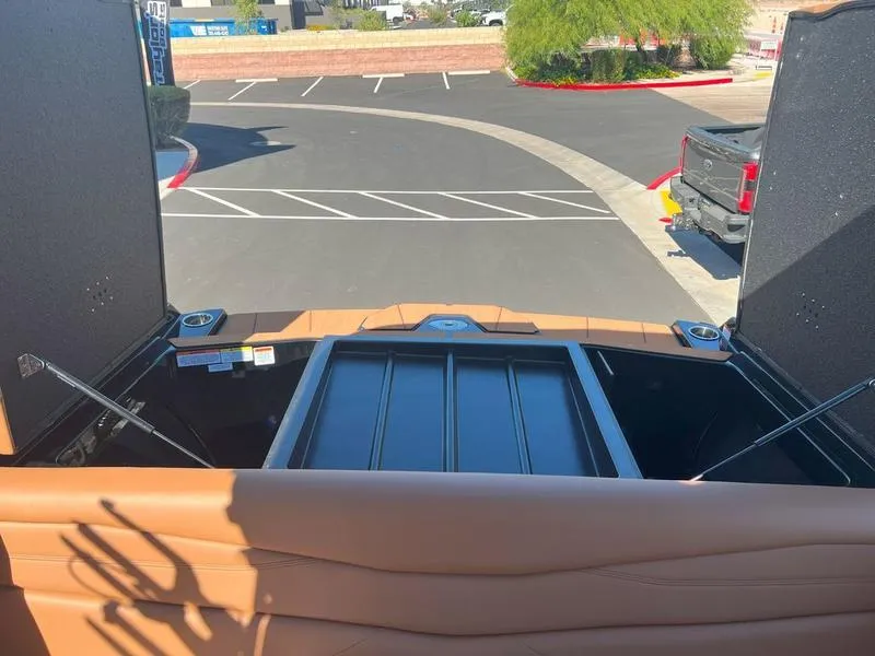 Slide: The Image of Open storage compartment of 2025 Axis A225 boat in parking lot. - 30