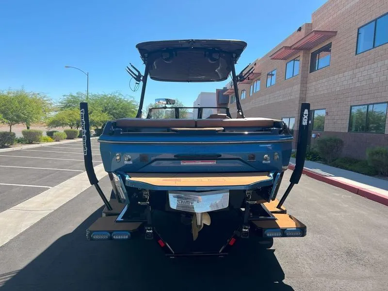 Slide: The Image of 2025 Axis A225 boat parked outdoors, rear view, sunny day. - 4