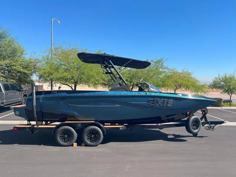 Slide: The Image of 2025 Axis A225 boat on trailer, parked outdoors under clear blue sky. - 8