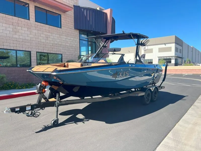 Slide: The Image of 2025 Axis A225 boat on trailer, parked outside modern building. - 9