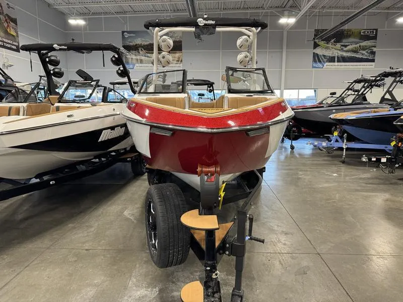 Slide: The Image of 2024 Malibu 25 LSV boat in showroom, red and white exterior. - 11