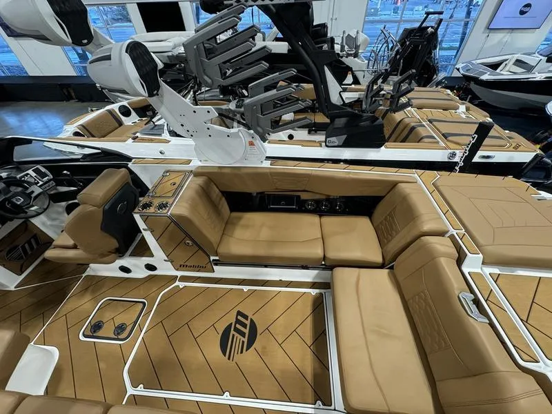 Slide: The Image of 2024 Malibu 25 LSV boat interior with tan seating and modern design. - 5