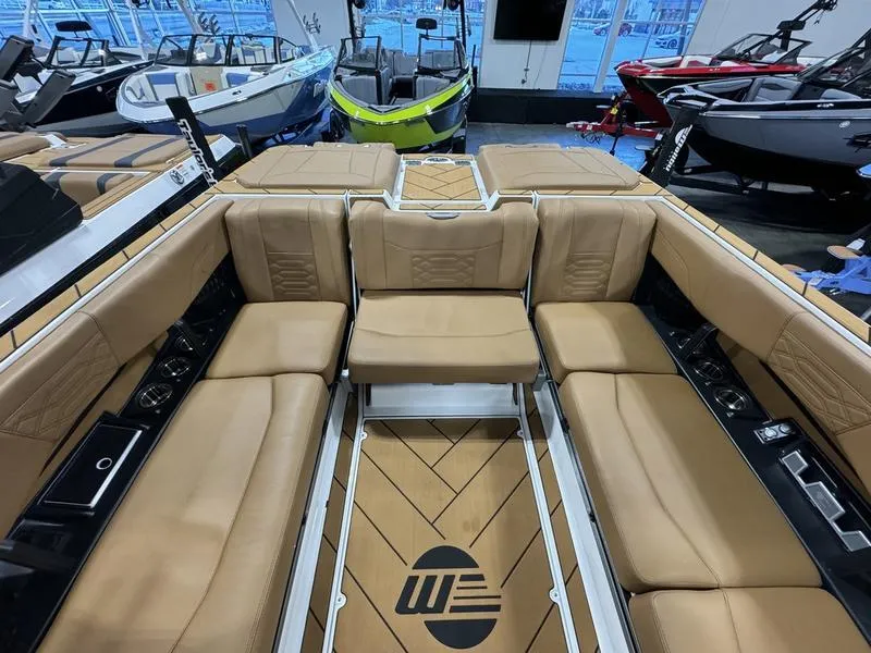 Slide: The Image of 2024 Malibu 25 LSV boat interior with tan leather seating and sleek design. - 6