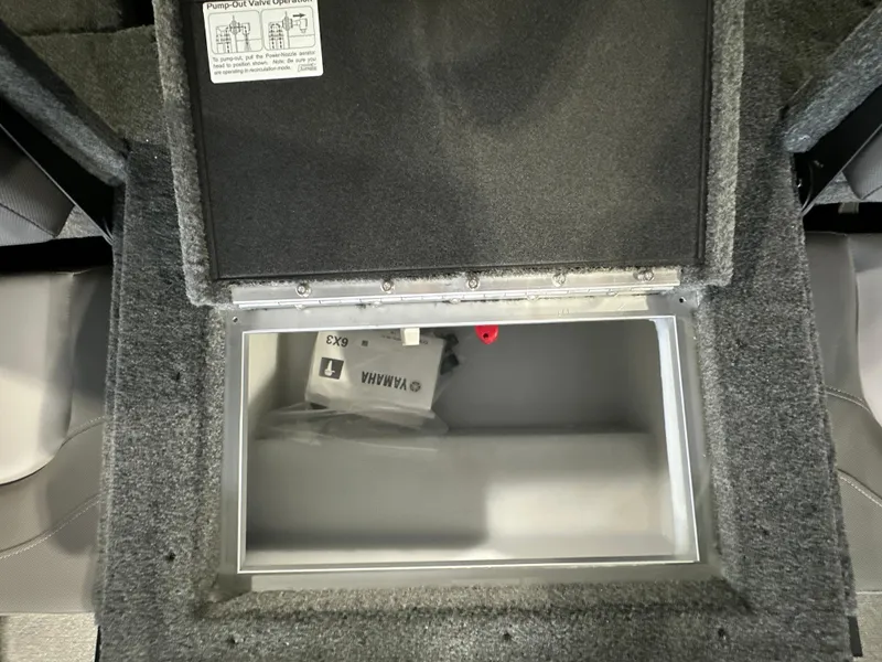 Slide: The Image of 2025 Smoker Craft Adventurer 188 DC storage compartment with Yamaha accessory inside. - 11