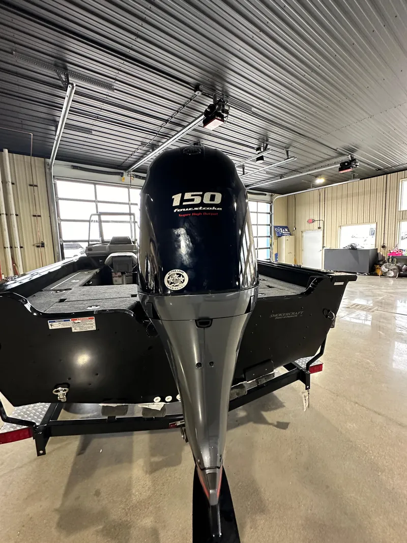 Slide: The Image of 2025 Smoker Craft Adventurer 188 DC boat with 150 horsepower engine in a showroom. - 15