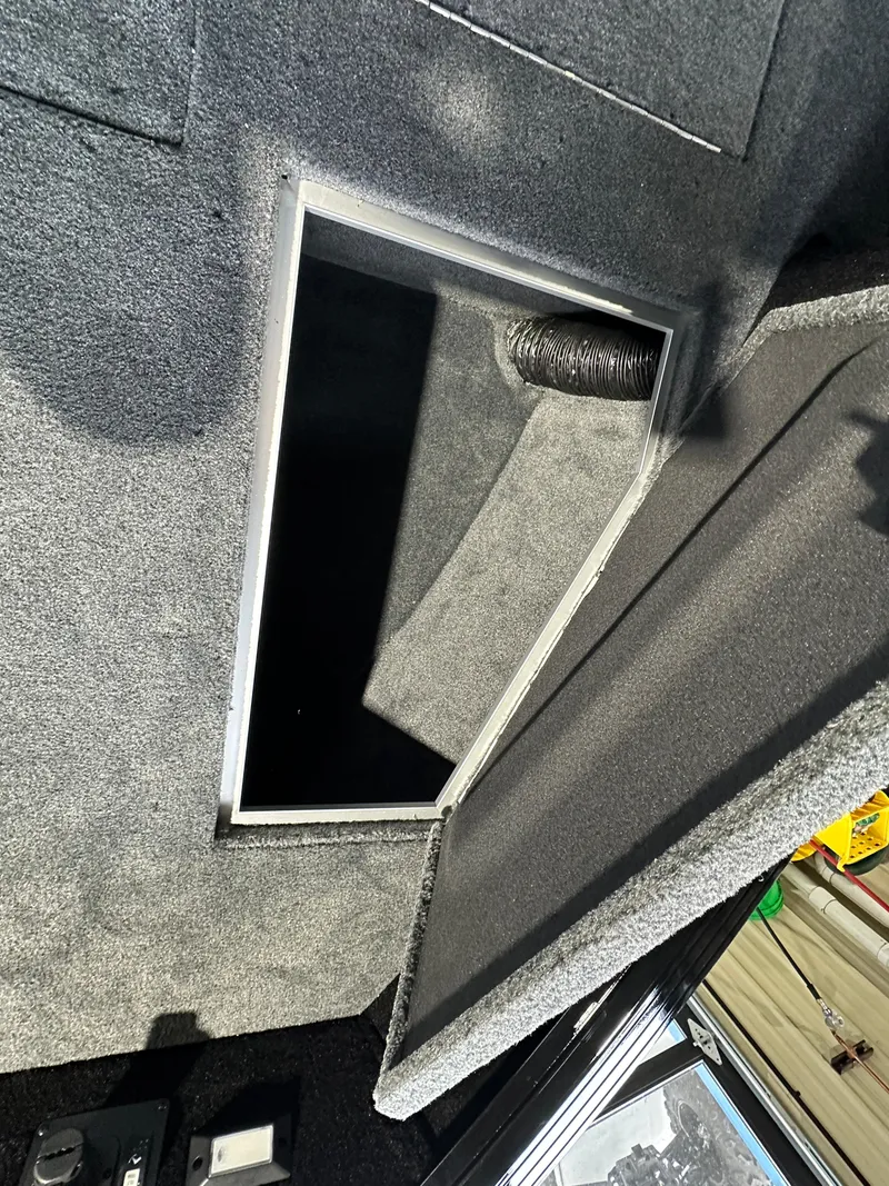 Slide: The Image of 2025 Smoker Craft Adventurer 188 DC interior storage compartment with open hatch. - 5