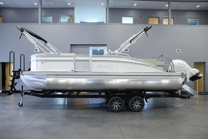 Slide: The Image of 2024 Barletta ARIA A22UC pontoon boat on trailer in showroom. - 0