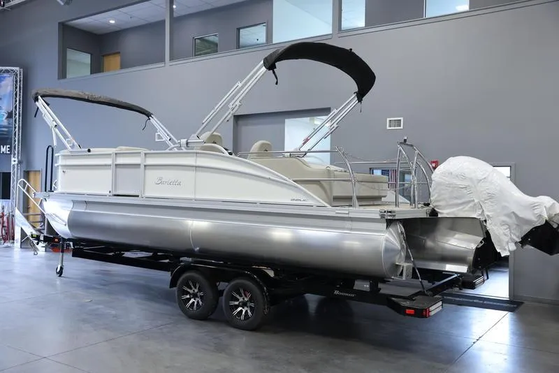 Slide: The Image of 2024 Barletta ARIA A22UC pontoon boat on trailer in showroom. - 1