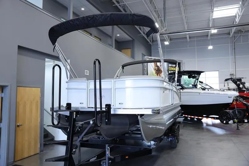 Slide: The Image of 2024 Barletta ARIA A22UC pontoon boat displayed indoors. - 11