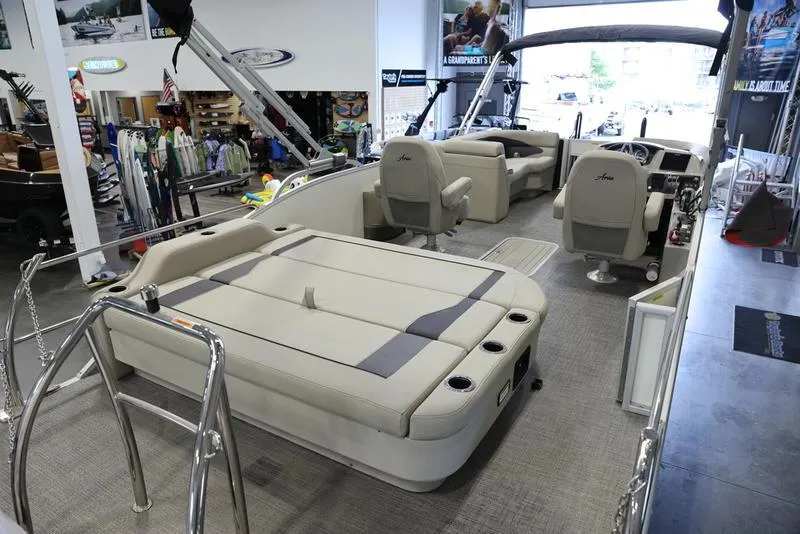 Slide: The Image of 2024 Barletta ARIA A22UC pontoon boat interior with seating and helm in showroom. - 5