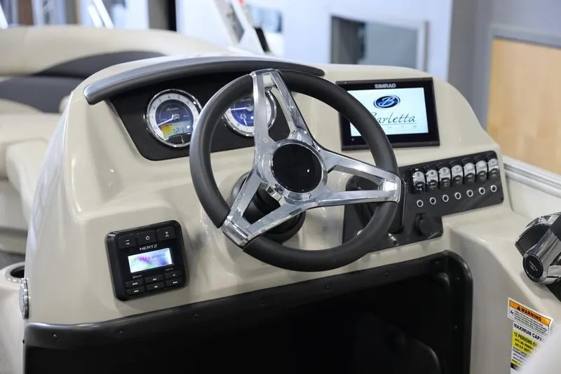 Slide: The Image of 2024 Barletta ARIA A22UC boat dashboard with steering wheel and control panel. - 6