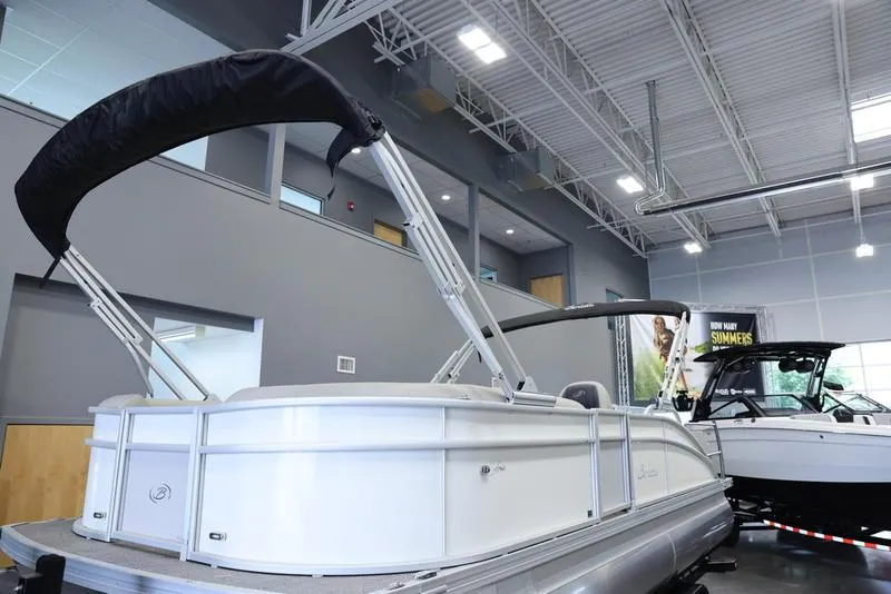 Slide: The Image of 2024 Barletta ARIA A22UC pontoon boat displayed indoors. - 8