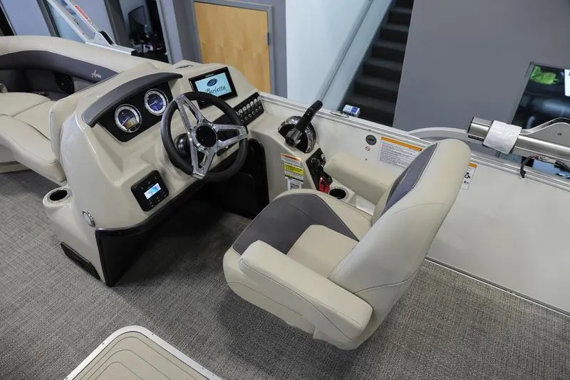 Slide: The Image of 2024 Barletta ARIA A22UC boat interior with steering wheel and captain's chair. - 9
