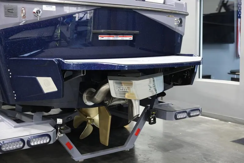 Slide: The Image of 2024 Axis T250 boat stern with propeller and swim platform in showroom. - 4