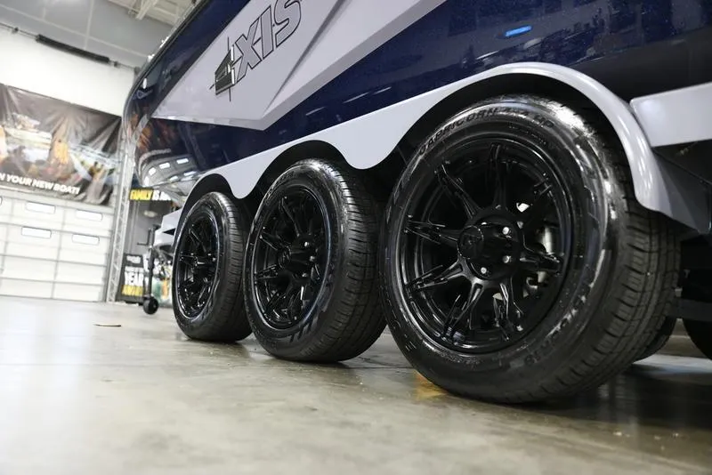 Slide: The Image of 2024 Axis T250 boat trailer with sleek black wheels in a showroom. - 6