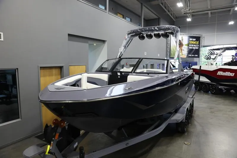 Slide: The Image of 2024 Axis T250 boat displayed indoors on a trailer. - 7