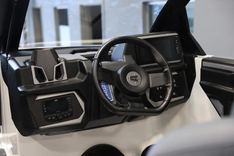 Slide: The Image of 2024 Axis A225 boat dashboard with modern steering wheel and digital display. - 10