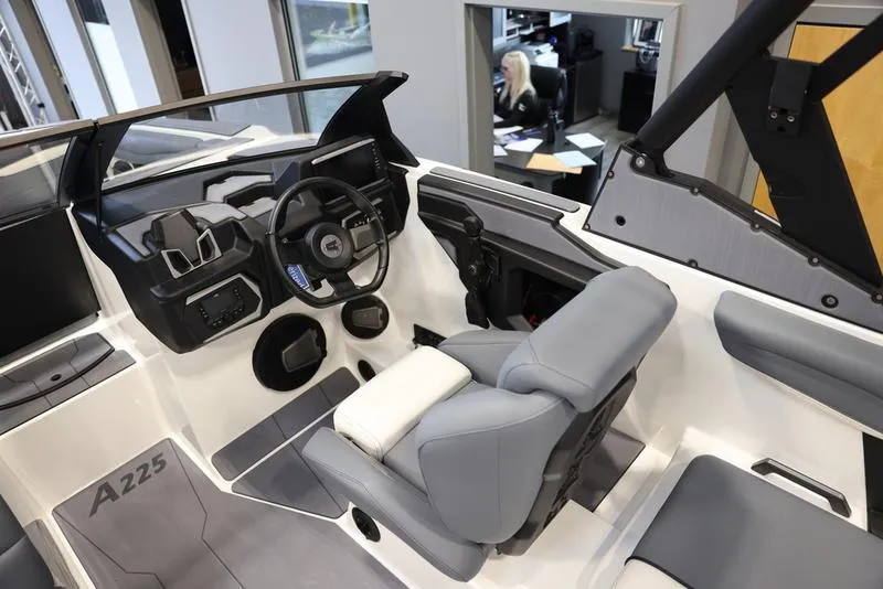 Slide: The Image of 2024 Axis A225 boat interior with modern steering and seating. - 12
