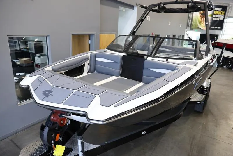 Slide: The Image of 2024 Axis A225 boat with sleek design and modern interior in showroom. - 17