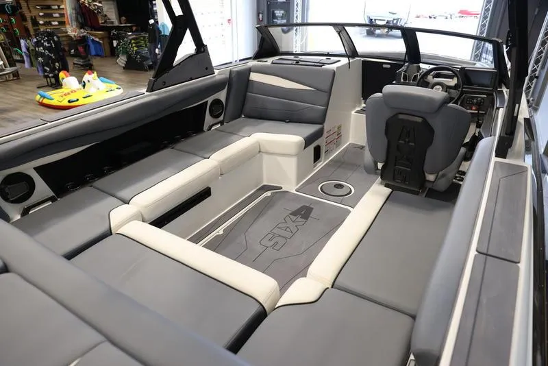 Slide: The Image of 2024 Axis A225 boat interior with gray seating and modern dashboard design. - 4