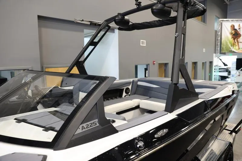 Slide: The Image of 2024 Axis A225 boat with sleek design and modern interior in showroom. - 8