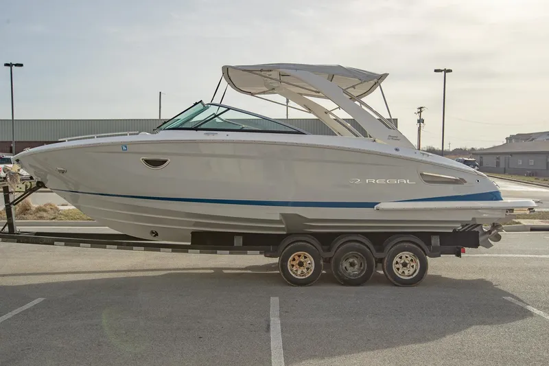 Slide: The Image of 2022 Regal 2800 Bowrider boat on trailer in parking lot. - 0