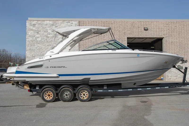 Slide: The Image of 2022 Regal 2800 Bowrider boat on trailer, parked outdoors. - 1