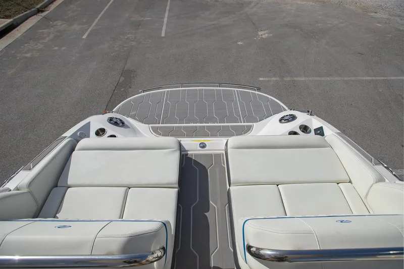 Slide: The Image of 2022 Regal 2800 Bowrider boat interior with white seating and sleek design. - 10