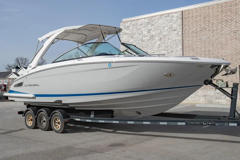 Slide: The Image of 2022 Regal 2800 Bowrider boat on trailer, parked outdoors. - 2