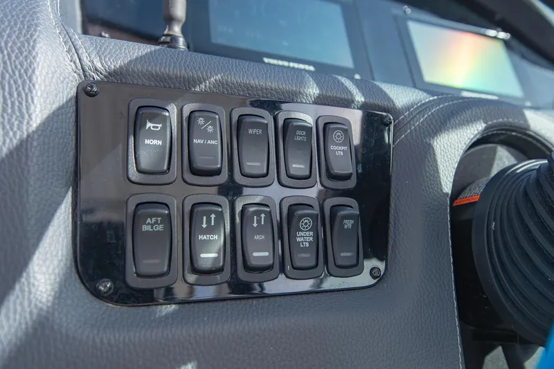 Slide: The Image of Control panel of 2022 Regal 2800 Bowrider boat with various switches. - 28