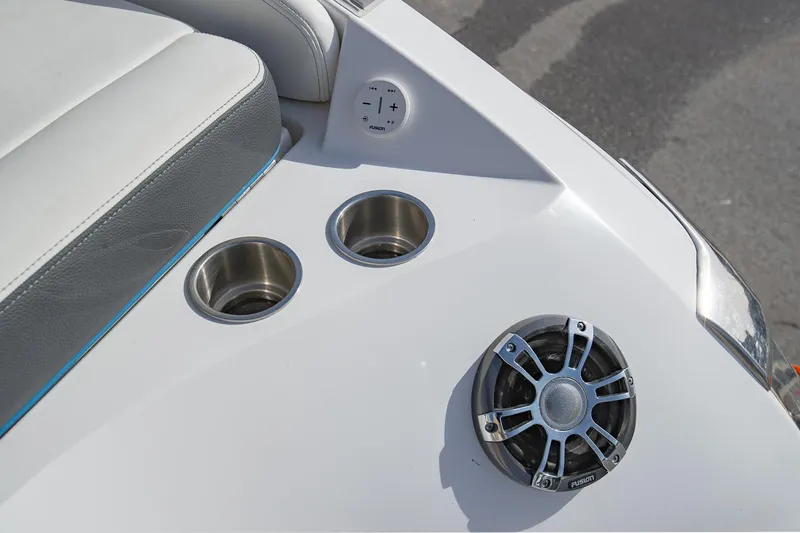 Slide: The Image of 2022 Regal 2800 Bowrider boat interior with cup holders and speaker. - 6