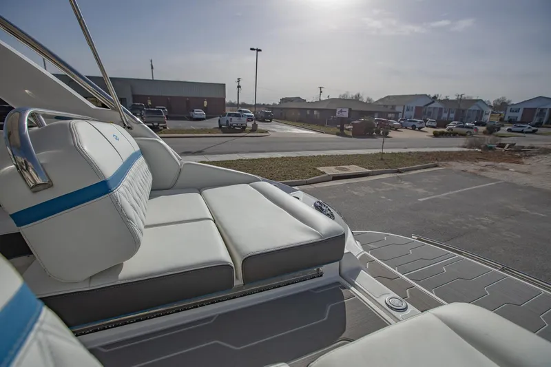 Slide: The Image of 2022 Regal 2800 Bowrider boat with white seating in a parking lot. - 9