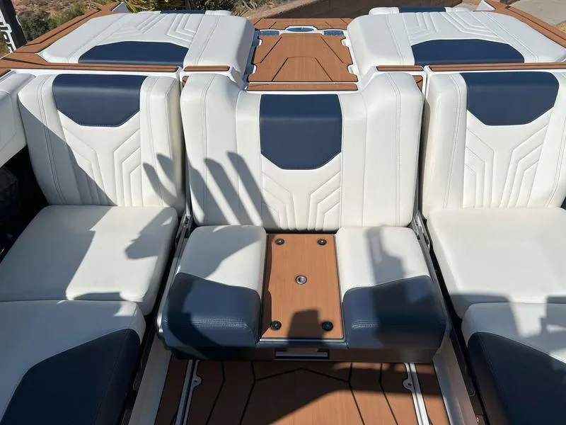 Slide: The Image of 2025 Malibu 25 LSV boat interior with white and blue seating. - 20
