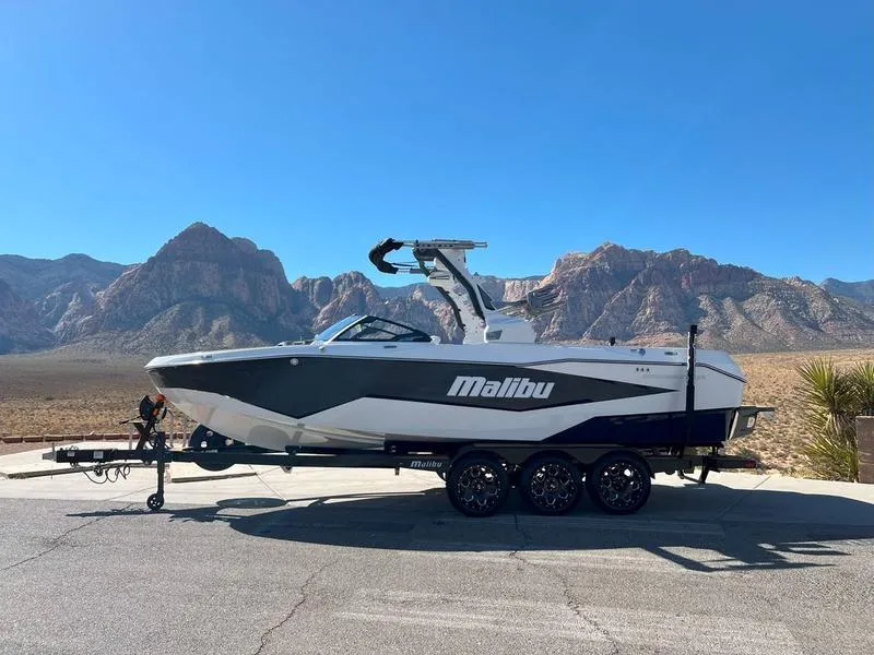 Slide: The Image of 2025 Malibu 25 LSV boat on trailer with mountain backdrop. - 3