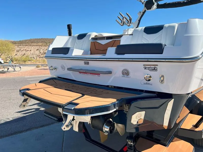 Slide: The Image of 2025 Malibu 25 LSV boat rear view with swim platform and wakeboard tower. - 4